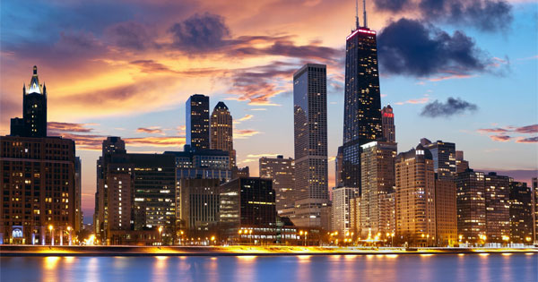 Iconic Chicago skyline reflecting on Lake Michigan at sunset