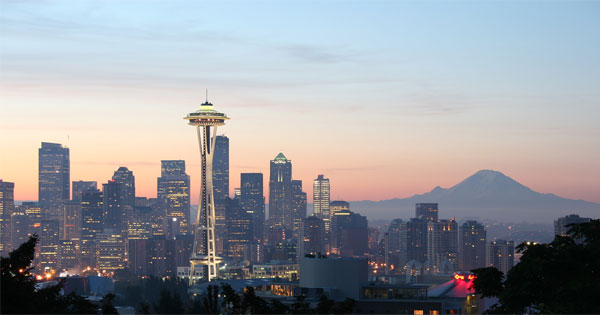 Rainy Seattle skyline with Space Needle surrounded by lush green trees